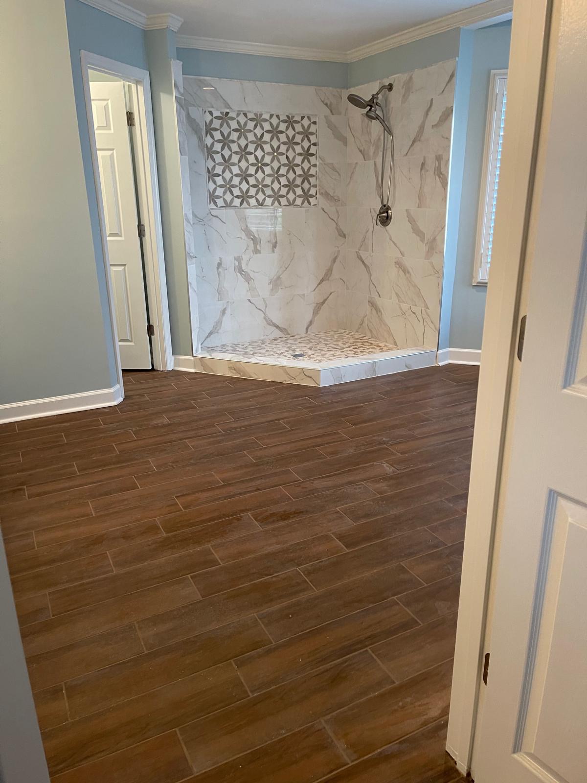 Wood tile floor and marble shower combo